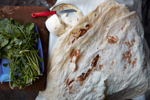 Fresh farm cheese and herbs wrapped with thin lavash bread: a perfect snack.