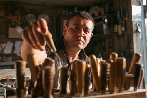 Woodcarver Armen Ohanyan chooses from among his handmade carving tools in his workshop in Sisian.