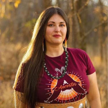 A woman with a beaded top on a green background.