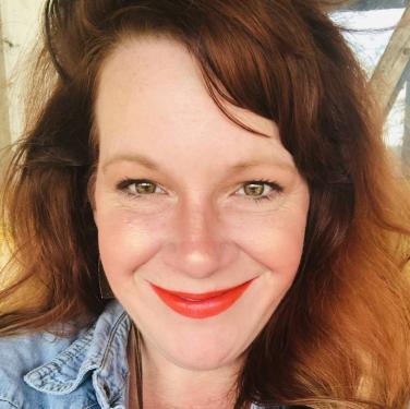 A selfie of a red-haired woman in flannel.