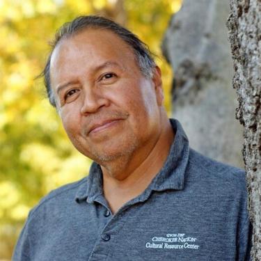 Close-up of a man wearing a gray polo shirt.