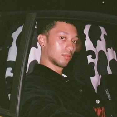 A young person in the passenger seat of a car.