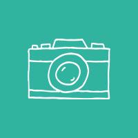 Illustrated film camera in an aqua-colored circle.