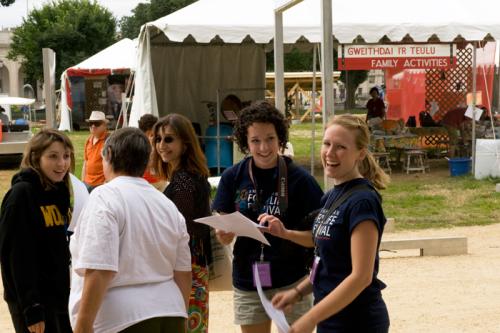 Interns Kathryn Young (right) and Sara Manco (center) chat before the Welsh hymn singing at the 2009 Smithsonian Folklife Festival.