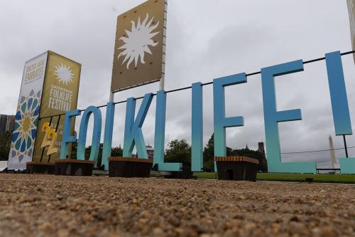 Large letters spelling out 22 FOLKLIFE!, painted yellow and blue, against a gray sky.