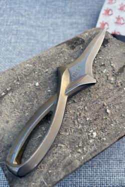 Shucking knife made of metal, with a loop handle.