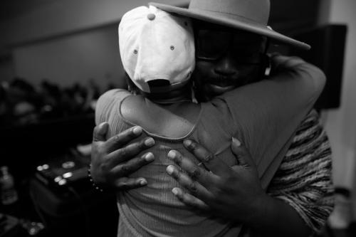 Two people embrace indoors.