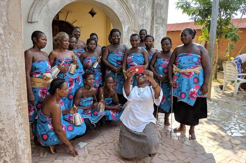 Festival director Sabrina Lynn Motley poses with women of the historic royal family of Hogbonou, Porto-Novo, Benin.
