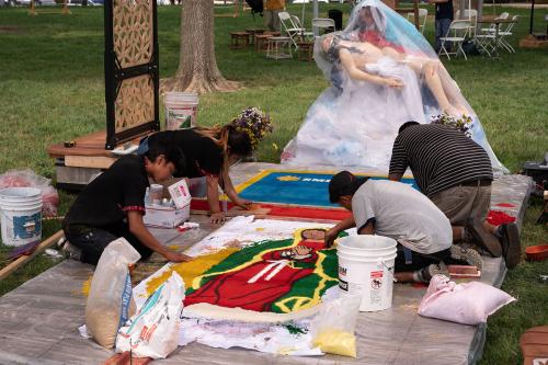 Artists from the Guate-Maya D.C. team at work on La Virgen de Guadalupe on the second alfombra, including Ubaldo Sanchez, Kevin Cabrera Sánchez, and Rocsana Sanchez.