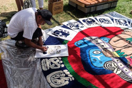 Ubaldo Sánchez at work using pre-made stencils of Guatemalan glyphs of the Haab’, the 365-day Maya solar calendar with eighteen months.