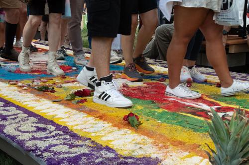 Detail of visitors walking onto of La Virgen de Guadalupe on the second alfombra.