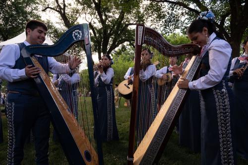 Two of the Mexican harpists of the Mariachi Aztlán high school group from Tucson, Arizona, during the closing ceremony of the second alfombra.