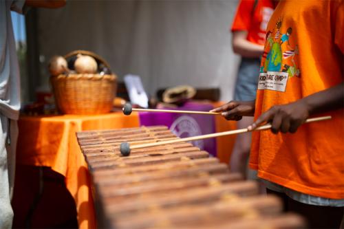 A child’s hands playing the marimba.
