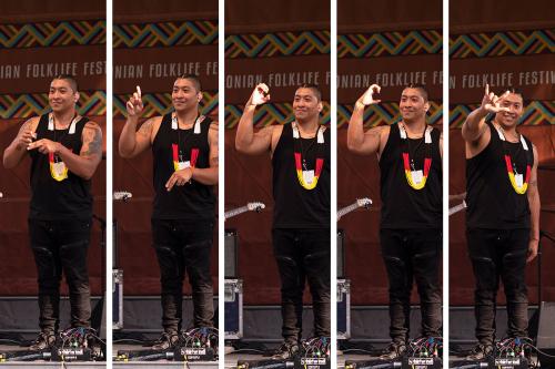 Collage of five photos of the same man doing a sequence of ASL signs. First, he brings together his pointer and middle fingers together to sign NAME. Then the letters for D, O, C, which mimic the shapes of the letters. Finally, the sign for I LOVE YOU is 