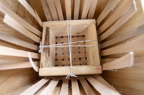 Close-up on the inside of the basket in progress, with a square-shaped frame set inside.