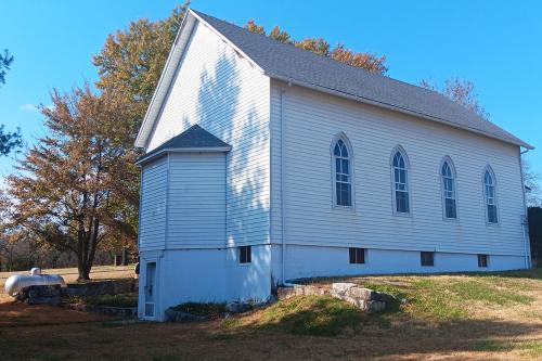 A simple white church exterior.