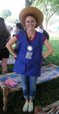 Intern Carly Hafner models the fashionable outfit the volunteer greeters will wear at the Festival.