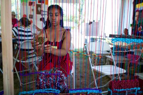 Sydney Morrow works on the Fresno State loom in the Campus and Community program. Photo by Carsten Schmidt, Smithsonian Institution