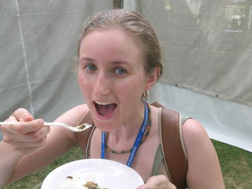 Intern Heather Darnell enjoys a crunchy cricket.