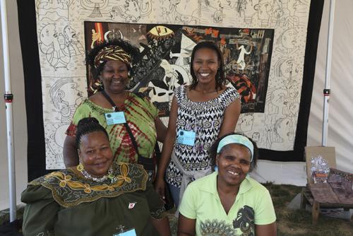 Nomvula Mashoai-Cook, Unathi Meslane, Beauty Ndlovu, and Lobolile Ximba pose in front of one of their art pieces in the Common Threads tent of the &ldquo;Creativity and Crisis&ldquo; program. Photo by Francisco Guerra, Smithsonian Institution