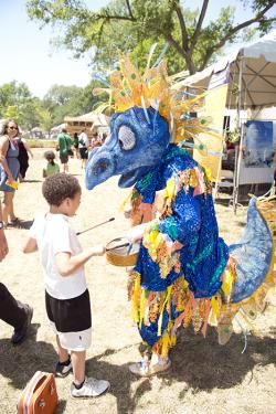 The West Virginia University Steel Drum Ensemble mascot entertains a young visitor in the &ldquo;Campus and Community&rdquo; program. Photo by Walter Larrimore, Smithsonian Institution