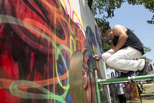 An artist works on a mural installation in the &ldquo;Citified&rdquo; program. Photo by Walter Larrimore, Smithsonian Institution