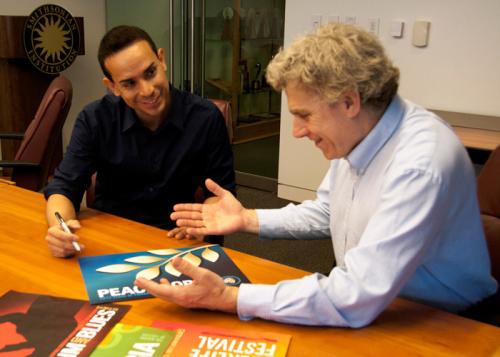 Peace Corps curator discusses layout with Senior Designer Josue Castilleja