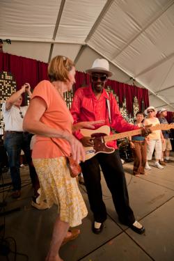 Fernando Jones dances with a visitor in the Motor City tent.
