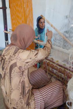 Fatima Akachmar (left) and Khadija Ighilnassaf demonstrate Moroccan weaving