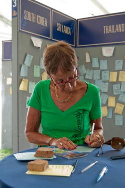 A Festival visitor writes a message to leave at the RPCVillage, a space where returned Peace Corps volunteers are sharing and exchanging messages