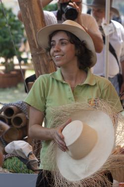 Colombia program presenter Olga Costa helps with a demonstration about hat weaving.