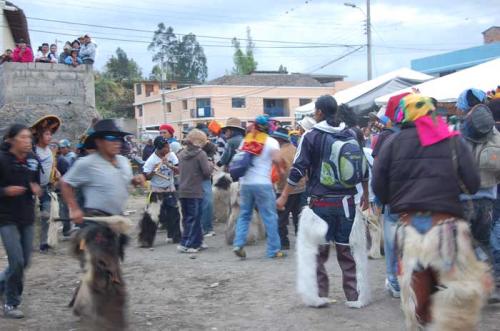 A photo from 2012 of members of Hatun Kotama dancing and performing during the Hatun Puncha-Inti Raymi festival in front of San Juan Capilla (St. John's Chapel).