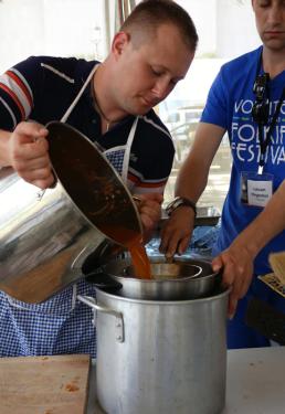 Pouring stew broth through the colander. 