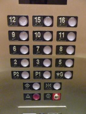 An elevator in a building in China that’s missing its fourth, thirteenth, and fourteenth floors due to number superstitions.