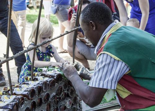 Isaac Kibe gets some assistance in building the Kitengela Glass Hut.