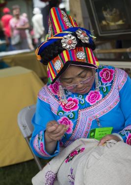 Xingxiu Li demonstrates Qiang embroidery from Sichuan Province.