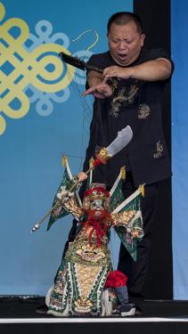 A puppeteer from the Quanzhou Puppet Troupe brings a menacing character to life.