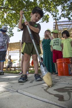 Practicing water calligraphy in the China program's People's Park.