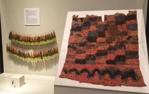 A belt made of parrot feathers from the 1920s shares a display with a feathered tunic from the years 1000-1500 in The Great Inka Road: Engineering an Empire exhibition. Photo by Georgia Dassler, Ralph Rinzler Folklife Archives