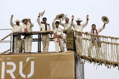 The Q'eswachaka Bridge builders waved from their completed structure. They stayed an extra day to disassemble the bridge; half with go into the National Museum of the American Indian in D.C., and the other half to the museum's location in New York City. P