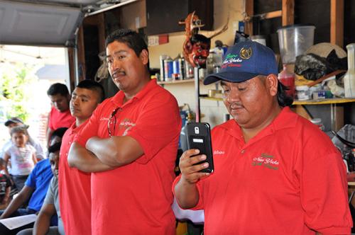 Diego Solano of Grupo Nuu Yuku/Danza de los Diablos de San Miguel Cuevas records a presentation about the preparations for the Smithsonian Folklife Festival to share on social media. Photo by Amy Kitchener, courtesy of the Alliance for California Traditio