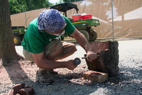 Behind the scenes, stone worker Bernat Vidal prepared a stone leftover from the construction of the Smithsonian Castle. Over the next few days, Bernat will carve a piece that will stay in Washington, D.C. Photo by Elisa Hough, Ralph Rinzler Folklife Archi