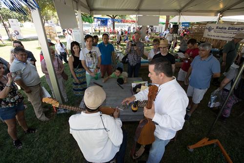 Instrument maker Ramón Gutiérrez (in white, left) had been working on building a requinto jarocho since the Festival began on Wednesday. Today he completed it, and instantly started a jam with Sounds of California presenter Russell Rodriguez (right). Phot