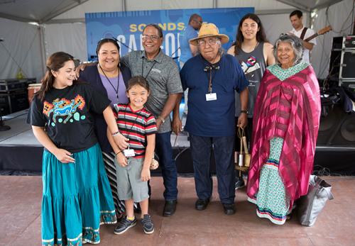 The Rodriguezes and the Arrow-weeds pose after the "Native Song Traditions" performance on the Sounds of California Stage &amp; Plaza. Photo by Francisco Guerra, Ralph Rinzler Folklife Archives