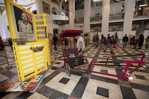After the rain drove us out of the tents, we moved our events inside the Arts and Industries Building. Throughout the Festival, visitors can see this artwork on display: <em>Goon Garage featuring The Rice Rocket</em> by Clement Hanami, part of