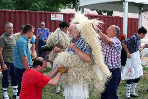 With their loud bells and rainbow-ribboned cone hats, the Joaldunak procession is quite a spectacle, but their process of getting dressed is quite an event as well. It takes a team to transform into sheep. Photo by Walter Larrimore, Ralph Rinzler Folklife