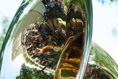 Grupo Nuu Yuku poses in the bell of Pedro Flores's sousaphone before their performance with Banda Brillo de San Miguel Cuevas at the Sounds of California Stage &amp; Plaza. Photo by Ronald Villasante, Ralph Rinzler Folklife Archives