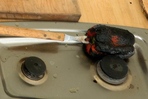 Roasting a red pepper. Photo by Bob Friedman, Ralph Rinzler Folklife Archives
