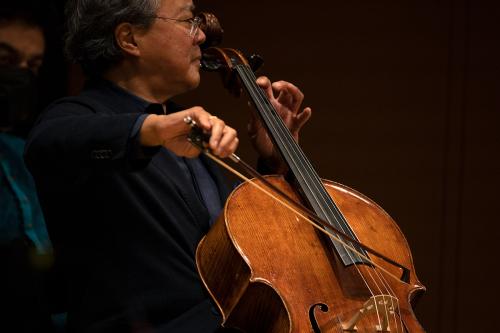 Man on stage playing cello.