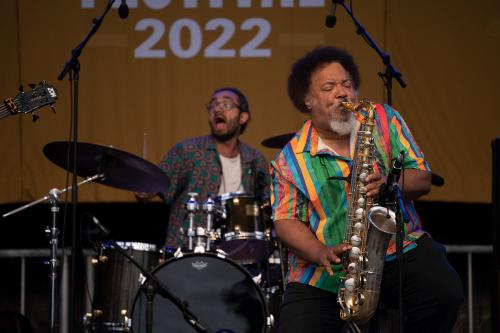 Drummer and saxophonist on stage.